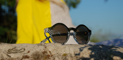 sunglasses on top of a rock