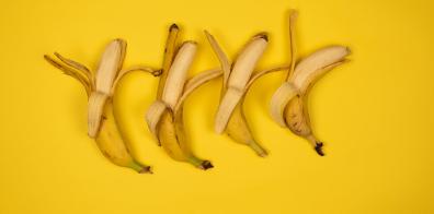 Four half-peeled bananas 