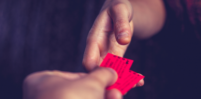 Two people exchanging tickets 