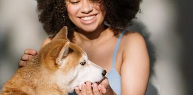 Woman feeding dog out of hand